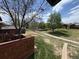 A lush, green backyard with walking paths and a small fence along the back porch at 1273 S Crystal Way, Aurora, CO 80012