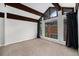 An airy bedroom with a large window featuring wooden beams and neutral paint at 1273 S Crystal Way, Aurora, CO 80012