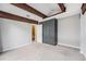 Cozy carpeted bedroom features exposed wood beam ceiling and closet with stylish blue wrapping at 1273 S Crystal Way, Aurora, CO 80012