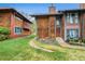 Charming multi-level townhome with wood siding, front lawn and well-kept landscaping in a cozy neighborhood setting at 1273 S Crystal Way, Aurora, CO 80012