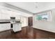 Modern kitchen with black counters, stainless steel appliances, a movable island, and plenty of natural light at 1273 S Crystal Way, Aurora, CO 80012