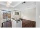 Modern kitchen with a movable island, light fixtures, and adjacent dining area, creating a functional and stylish space at 1273 S Crystal Way, Aurora, CO 80012