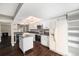 Bright kitchen with white cabinets, stainless steel appliances, a movable island, and an open layout, ideal for cooking at 1273 S Crystal Way, Aurora, CO 80012