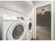 Convenient laundry area with modern washer and dryer and wire shelving for storage at 1273 S Crystal Way, Aurora, CO 80012