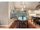 Charming dining area with views of the trees outside, a uniquely decorated table, and a vintage chandelier at 474 Silbrico Way, Castle Rock, CO 80108