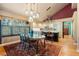 Elegant dining room featuring stylish furnishings, a vibrant rug, and abundant natural light from large windows at 474 Silbrico Way, Castle Rock, CO 80108