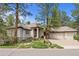 Beautiful beige home with a three car garage and well-maintained front yard, creating excellent curb appeal at 474 Silbrico Way, Castle Rock, CO 80108