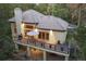 A view of the rear exterior showcasing the deck, stairs, and under deck patio at 474 Silbrico Way, Castle Rock, CO 80108