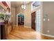 Bright foyer with hardwood floors, glass block detail, and open view of library at 474 Silbrico Way, Castle Rock, CO 80108