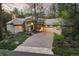 Charming home exterior with lush landscaping, a welcoming driveway and two car garage nestled in a wooded setting at 474 Silbrico Way, Castle Rock, CO 80108