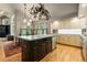 Large kitchen island with stone countertops, designer lighting, and stainless steel appliances, creating a modern space at 474 Silbrico Way, Castle Rock, CO 80108