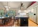 Gourmet kitchen with custom cabinets, a central island, stainless appliances and a separate dining area at 474 Silbrico Way, Castle Rock, CO 80108