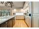 Well-lit kitchen with hardwood floors, stainless steel appliances, and custom cabinetry at 474 Silbrico Way, Castle Rock, CO 80108