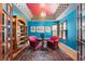 Bright living room featuring colorful walls, built-in bookcase, and unique ceiling design at 474 Silbrico Way, Castle Rock, CO 80108
