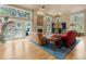 Bright living room with large windows, fireplace, hardwood floors, and comfortable seating area with stylish decor at 474 Silbrico Way, Castle Rock, CO 80108