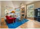 Bright living room with large windows, hardwood floors, a cozy fireplace, and a blue area rug at 474 Silbrico Way, Castle Rock, CO 80108