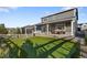 Beautiful backyard featuring a putting green, covered patio, and a white fence, perfect for outdoor enjoyment at 2637 Gray Wolf Pl, Castle Rock, CO 80104