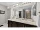 Well-lit bathroom with a large mirror, dark cabinets, and a shower for convenience at 2637 Gray Wolf Pl, Castle Rock, CO 80104