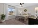 Comfortable bedroom featuring a ceiling fan, large window, and decorative wreath creating a relaxing space at 2637 Gray Wolf Pl, Castle Rock, CO 80104