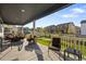 Inviting covered patio with comfortable seating, perfect for outdoor relaxation and entertaining with neighborhood views at 2637 Gray Wolf Pl, Castle Rock, CO 80104