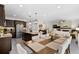 Open dining and living areas with table for eight adjacent to the modern kitchen and island at 2637 Gray Wolf Pl, Castle Rock, CO 80104