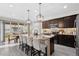 A modern kitchen featuring an island with bar seating, stainless steel appliances, and ample counter space at 2637 Gray Wolf Pl, Castle Rock, CO 80104