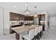 Modern kitchen featuring an island with bar seating, stainless steel appliances, and dark cabinets at 2637 Gray Wolf Pl, Castle Rock, CO 80104