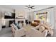 Bright and airy living room featuring a fireplace, plush seating, and large windows with natural light at 2637 Gray Wolf Pl, Castle Rock, CO 80104