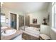 Well-lit bathroom featuring a soaking tub with a shower, double sinks, and neutral tones at 8300 Fairmount Dr # Qq102, Denver, CO 80247