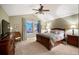 Serene bedroom featuring a dark wood bed set, ample natural light, and tasteful decor at 8300 Fairmount Dr # Qq102, Denver, CO 80247