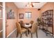 Comfortable dining room with a round table, wicker chairs, and a charming wall display at 8300 Fairmount Dr # Qq102, Denver, CO 80247