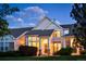 Inviting two-story home featuring classic architectural details, manicured landscaping and warm exterior lighting at 8300 Fairmount Dr # Qq102, Denver, CO 80247