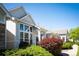 Charming exterior showcasing the building's architecture, complemented by lush greenery and well-maintained landscaping at 8300 Fairmount Dr # Qq102, Denver, CO 80247