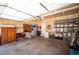 Spacious garage with ample storage, work bench, tools, and storage shelves at 8300 Fairmount Dr # Qq102, Denver, CO 80247
