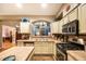 Functional kitchen with stainless steel appliances, neutral countertops, and open layout at 8300 Fairmount Dr # Qq102, Denver, CO 80247