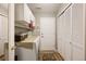 Functional laundry room with washer, dryer, storage cabinets, and closet space at 8300 Fairmount Dr # Qq102, Denver, CO 80247