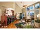 Bright living room featuring hardwood floors, a fireplace, and ample natural light from large windows at 8300 Fairmount Dr # Qq102, Denver, CO 80247