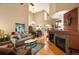 Inviting living room with hardwood floors, a cozy fireplace, and soaring ceilings, creating an open and airy atmosphere at 8300 Fairmount Dr # Qq102, Denver, CO 80247