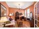 Comfortable living room with warm tones, a decorative chandelier, and ample natural light from the windows at 8300 Fairmount Dr # Qq102, Denver, CO 80247