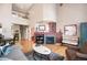 Spacious living room with a fireplace, hardwood floors, high ceiling and ample natural light at 8300 Fairmount Dr # Qq102, Denver, CO 80247