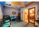 Cozy outdoor patio with comfortable seating, grill, shade, and access to the indoors at 8300 Fairmount Dr # Qq102, Denver, CO 80247