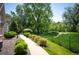 Well-maintained walking path surrounded by lush landscaping and greenery in a residential area at 8300 Fairmount Dr # Qq102, Denver, CO 80247