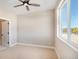 Cozy bedroom with neutral carpet, ceiling fan, and large window, creating a serene and welcoming space at 888 S Valentia St # 103, Denver, CO 80247