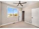 Sunny bedroom with carpet, ceiling fan, and closet, offering a comfortable living space with a beautiful view at 888 S Valentia St # 103, Denver, CO 80247