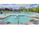 Large community pool with ample seating, tanning chairs and sun umbrellas at 888 S Valentia St # 103, Denver, CO 80247