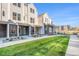 The attractive townhome features a well-manicured lawn, brick accents, and a covered entry for a welcoming appeal at 888 S Valentia St # 103, Denver, CO 80247