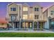 Townhome exterior showcasing brick accents, covered entryways, and modern design; a cozy and inviting facade at 888 S Valentia St # 103, Denver, CO 80247