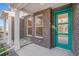 Inviting front porch with brick details, colorful front door, and xeriscaping for a low-maintenance appeal at 888 S Valentia St # 103, Denver, CO 80247