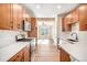 Modern kitchen featuring wood cabinets, white countertops, stainless steel appliances and abundant natural light at 888 S Valentia St # 103, Denver, CO 80247