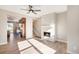 Bright living room with a modern fireplace, hardwood floors and a view to the kitchen with stainless steel appliances at 888 S Valentia St # 103, Denver, CO 80247